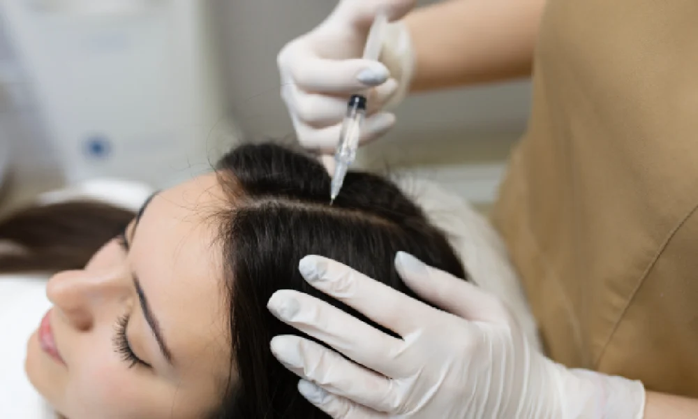 A women receiving hair restoration treatment in Freeland, MI from a professional